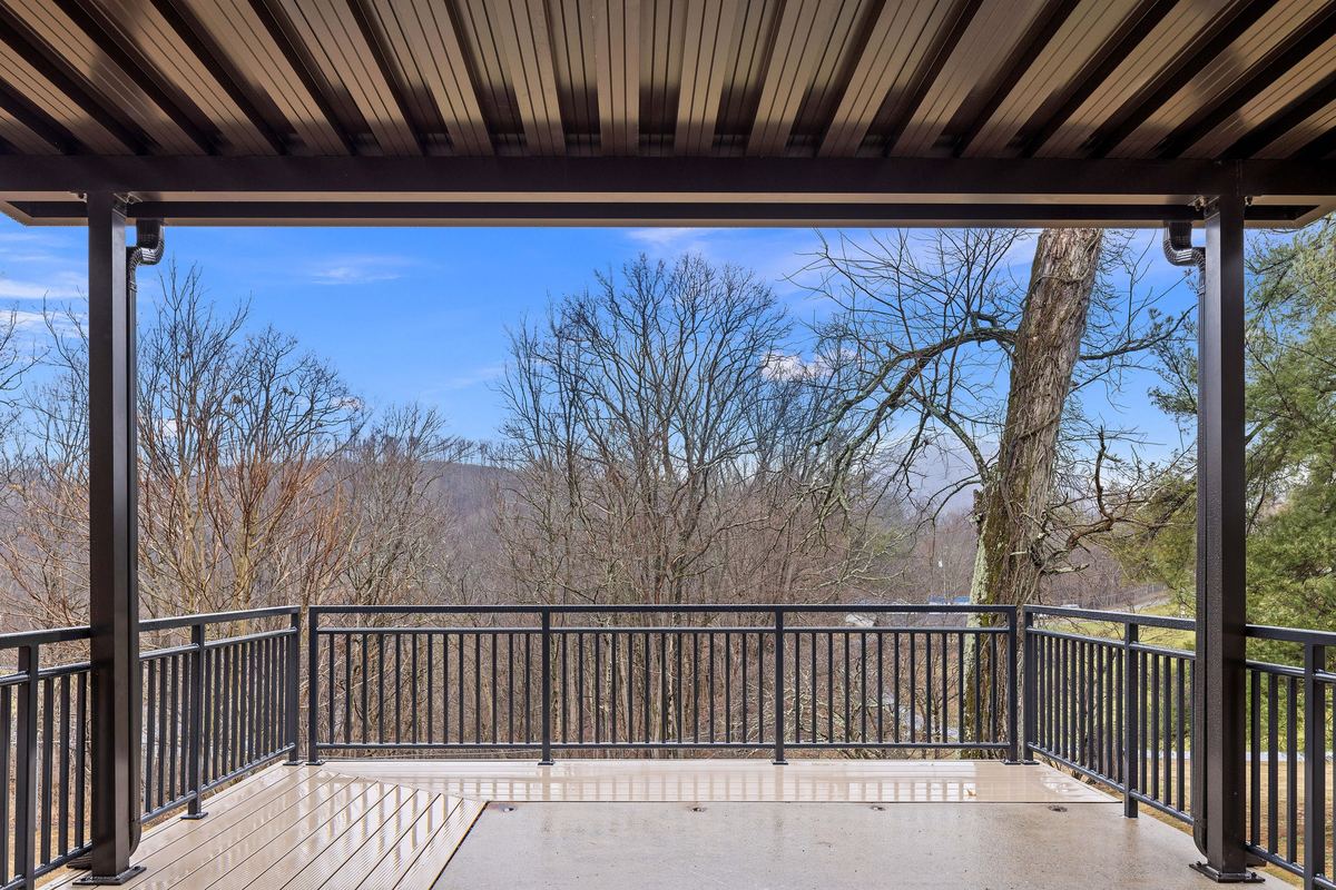 Covered porch looking out over the wooded ridge