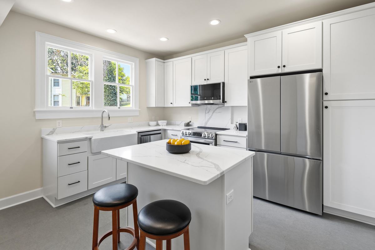 White kitchen with an island, farmhouse sink and a window over the counter, Staunton