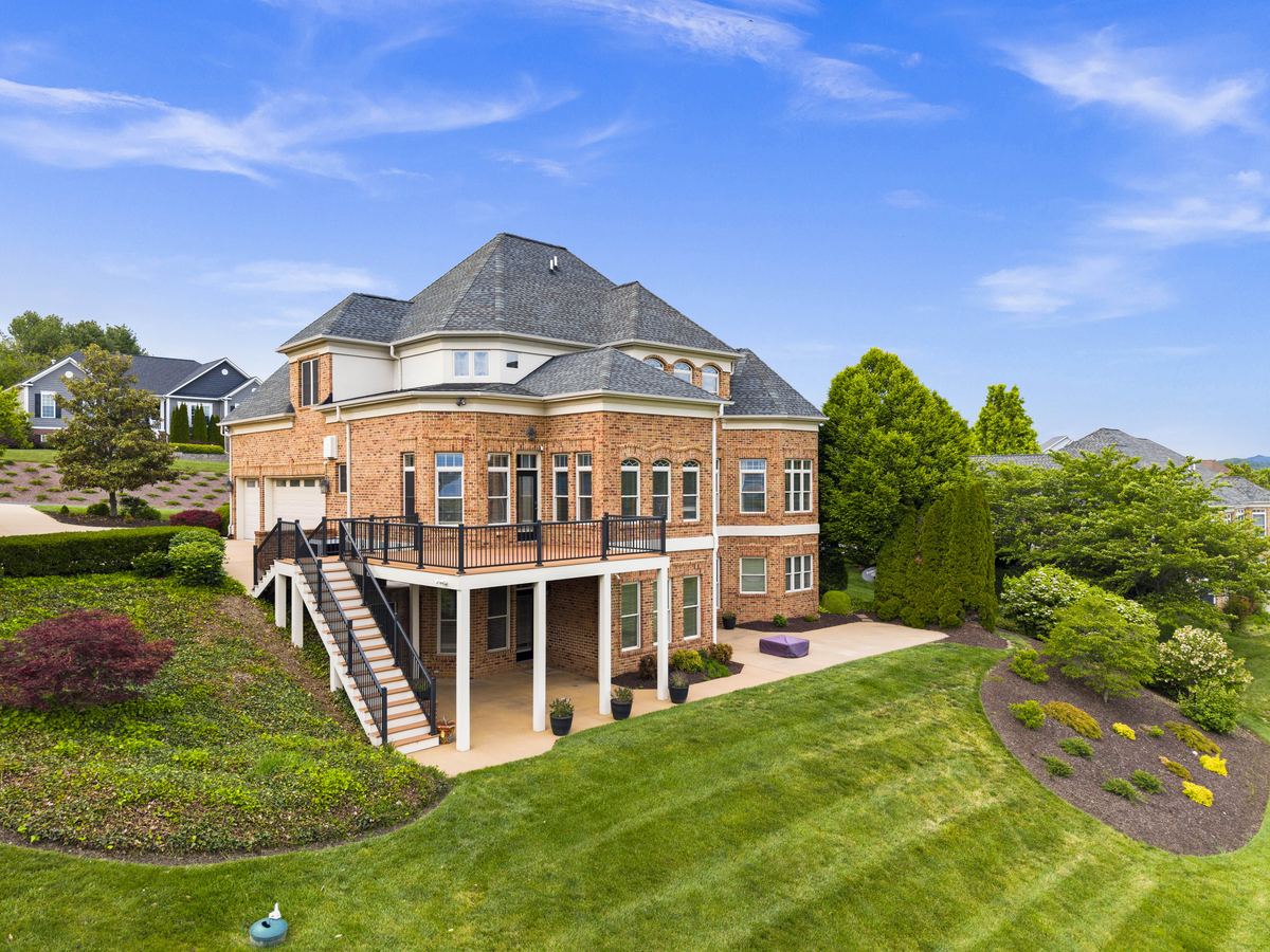 Aerial view of a brick estate home and its grounds