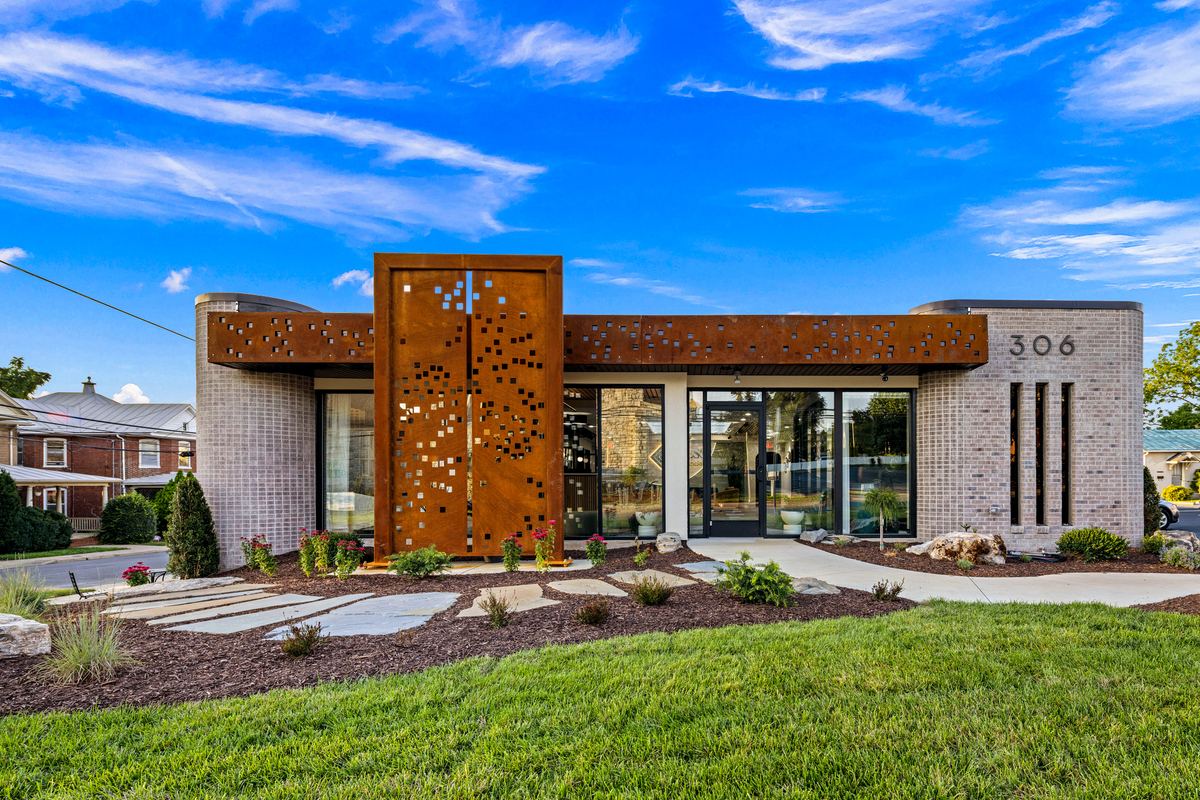 Hess Financial front elevation by day, corten panel with the tree cutout