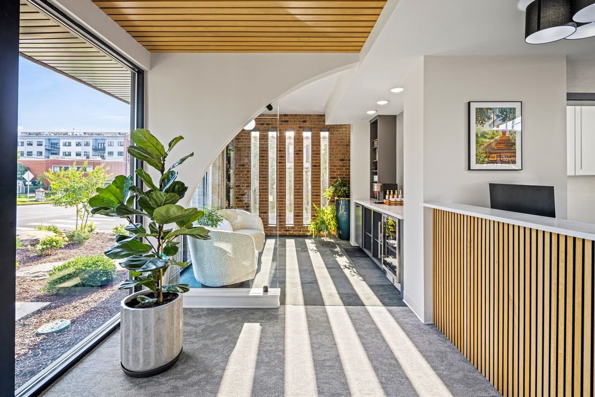 Curved nook with a white lounge chair and slatted light
