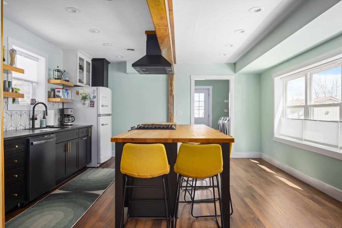 Mint kitchen with yellow stools, the Kit House