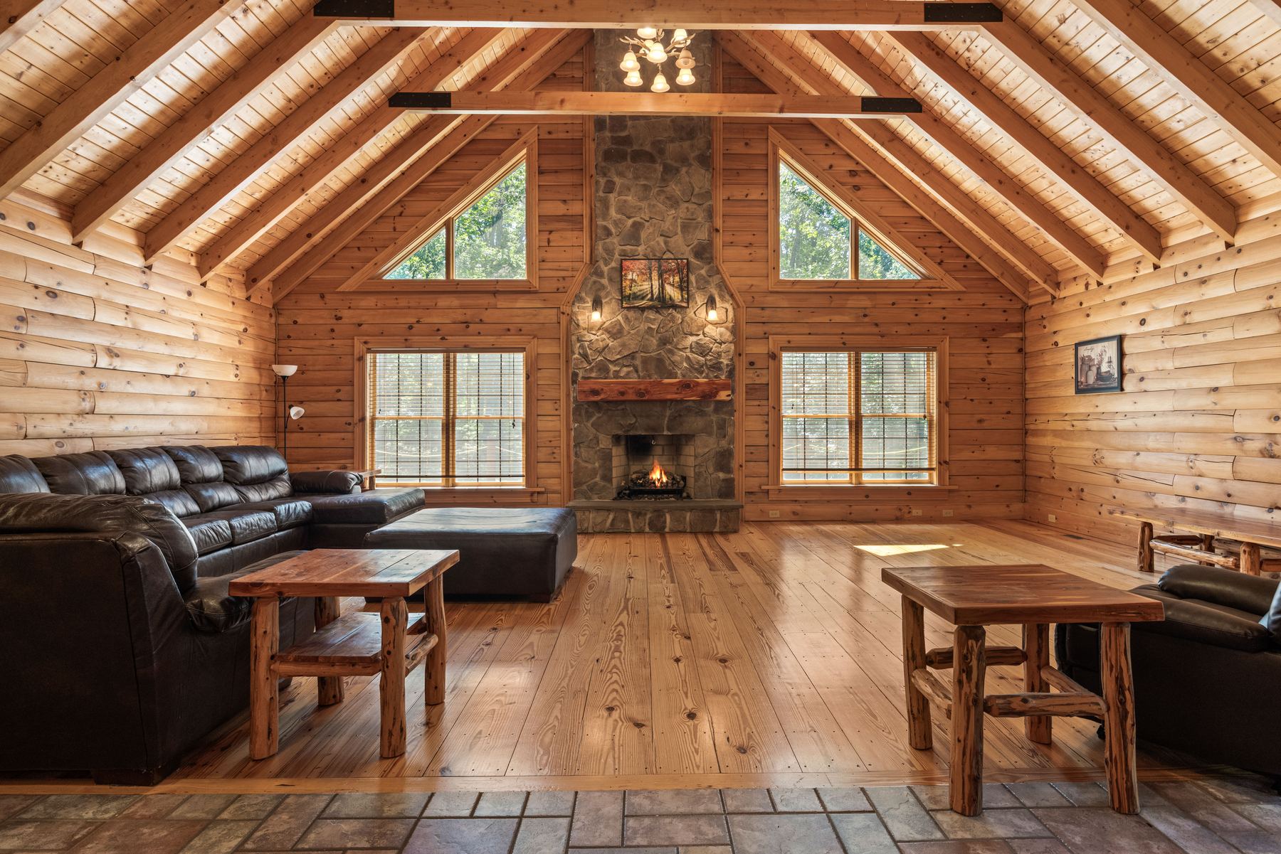 Great room in a timber-frame home with exposed trusses