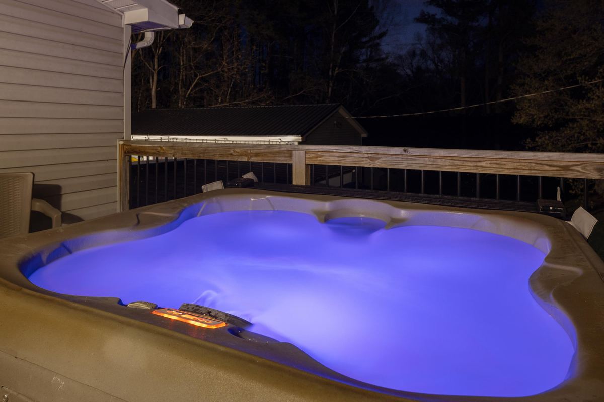 Pool lit at dusk beside a river house, Shenandoah