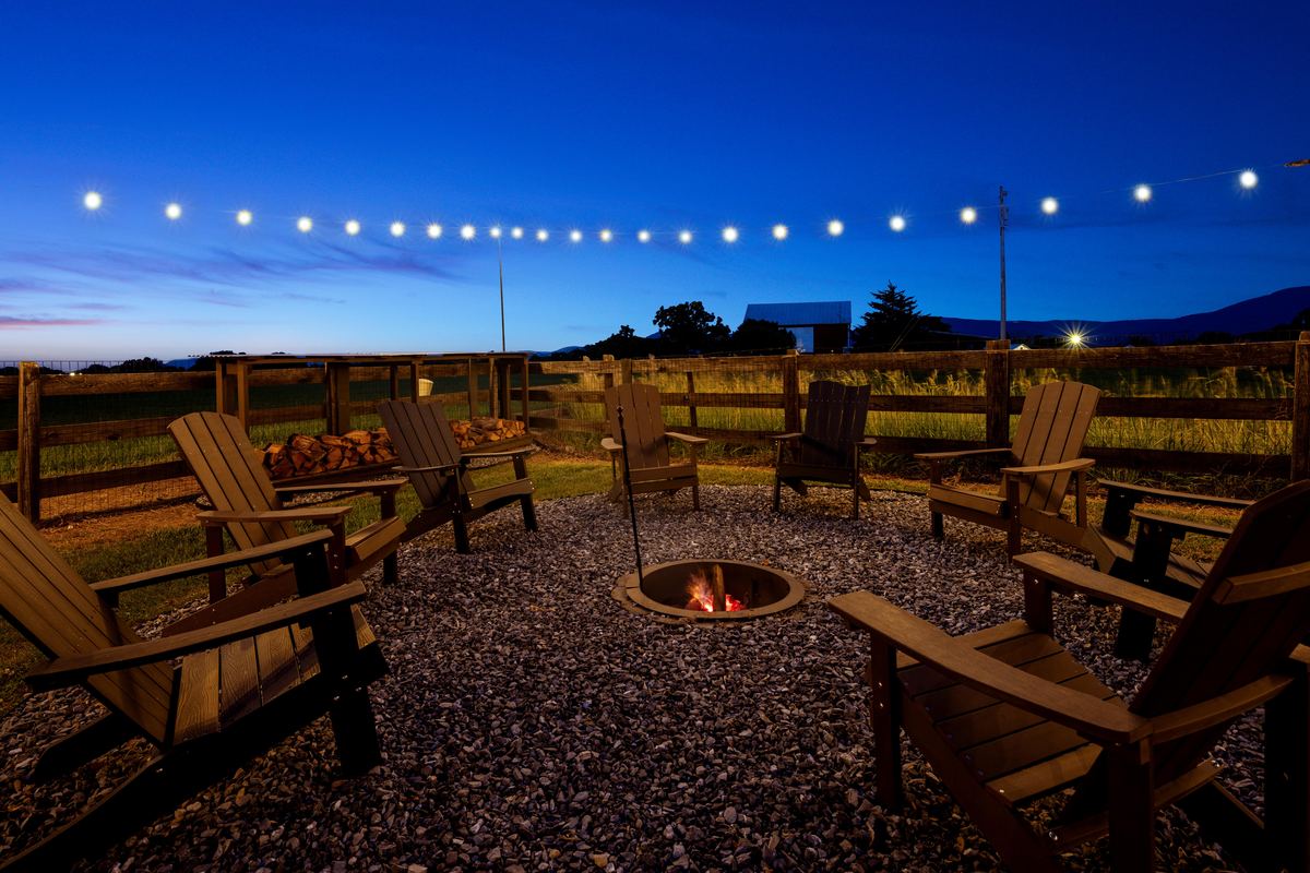 Fire pit and Adirondack chairs at twilight