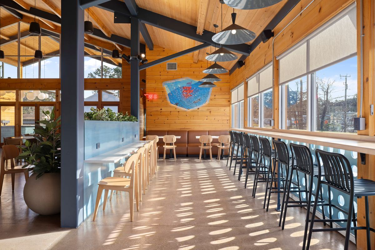 Taproom seating along a wall of windows, Virginia Beer Co