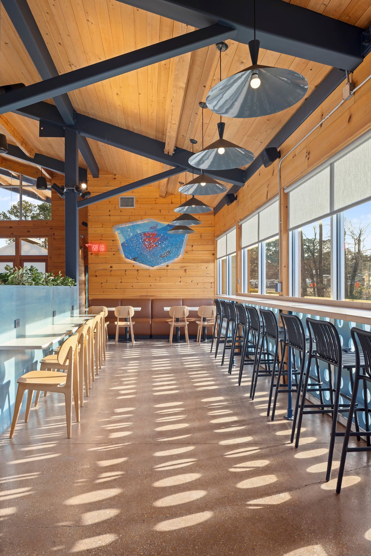 Taproom with dappled light across the floor and a long counter, Virginia Beer Co