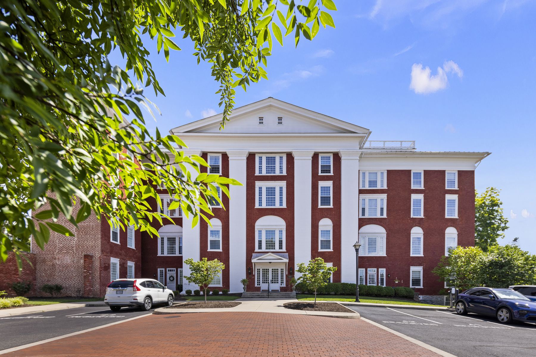 Brick condominium building with white columns at 100 Village Drive, Staunton
