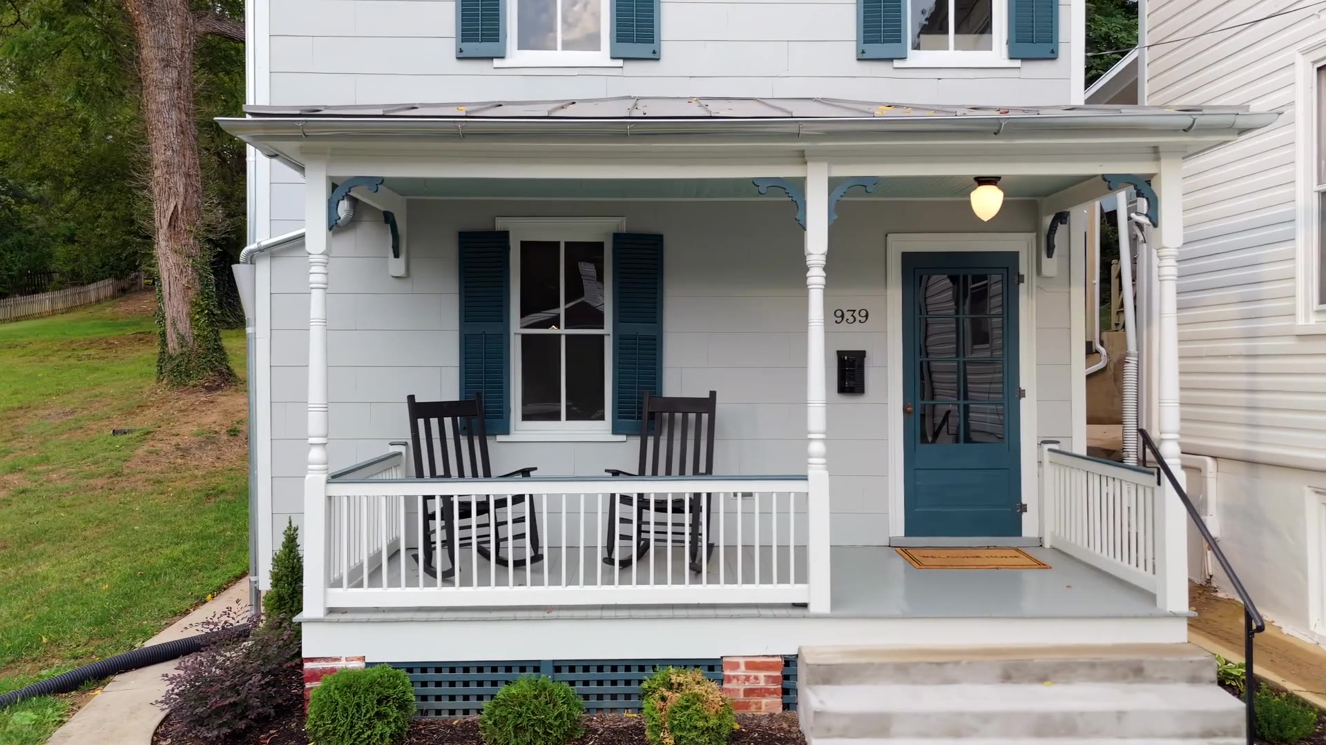 Frame from the 939 W Beverley St listing film, the restored porch with two rockers